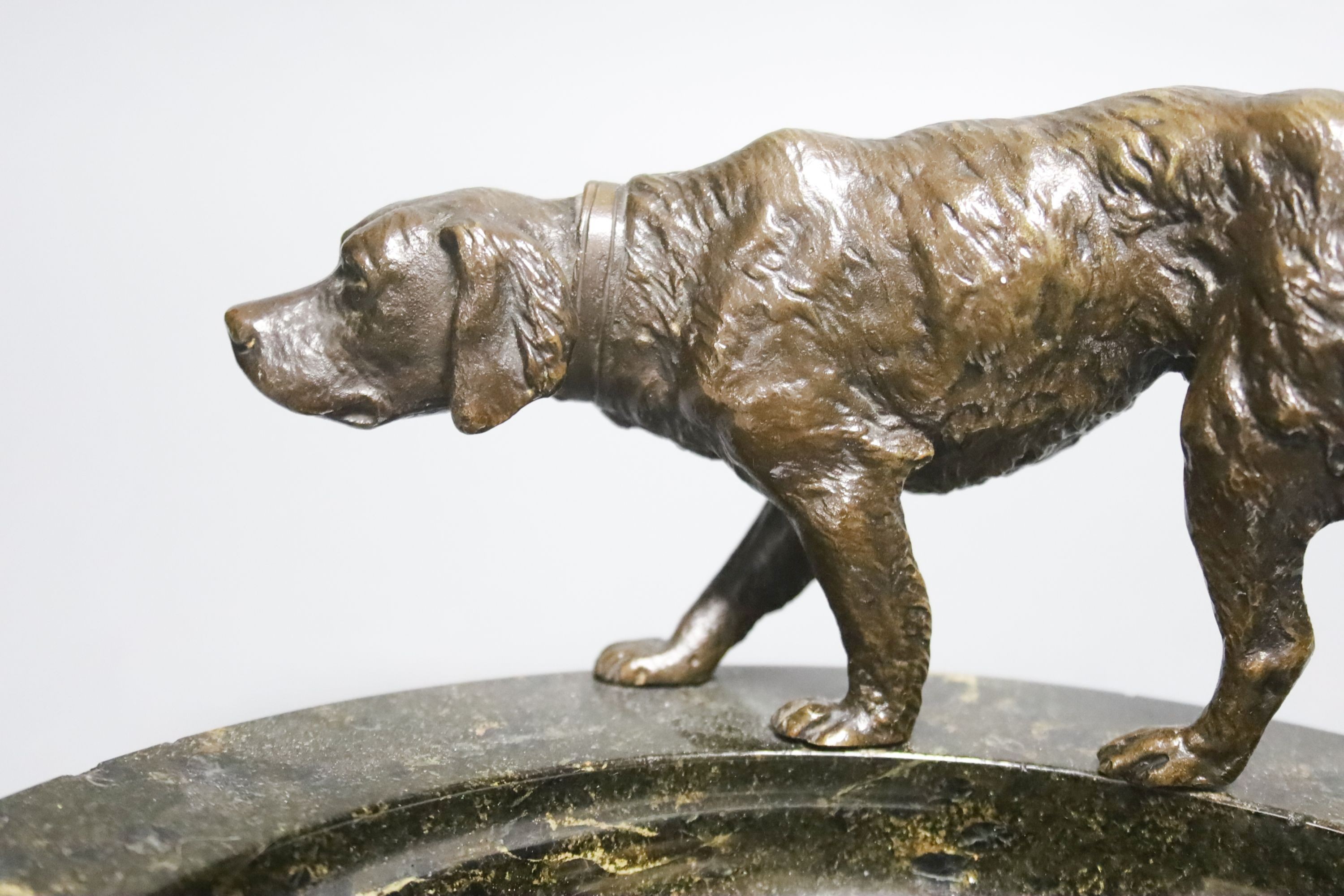 An early 20th century bronze 'setter' serpentine trinket dish, 25cm